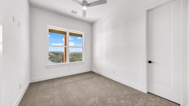 empty room with a ceiling fan, carpet, visible vents, and baseboards