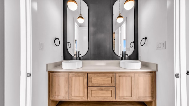 full bathroom with double vanity and a sink