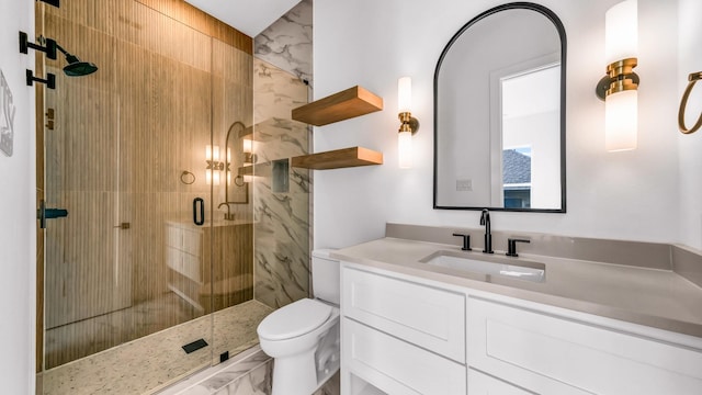 full bath featuring a stall shower, marble finish floor, vanity, and toilet