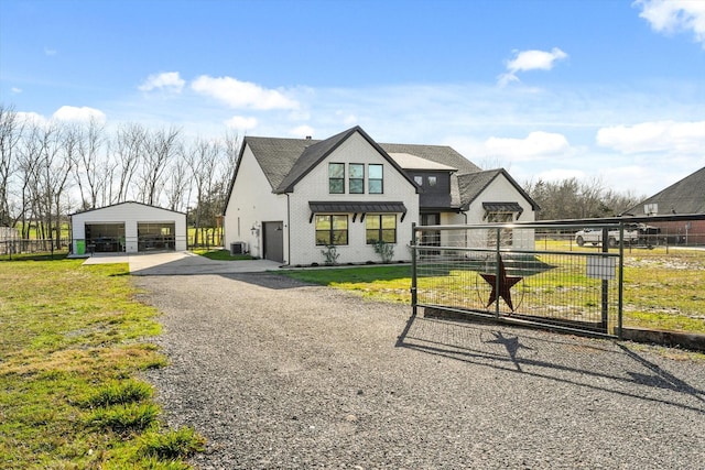 view of front of property featuring an outbuilding, a garage, and a front yard