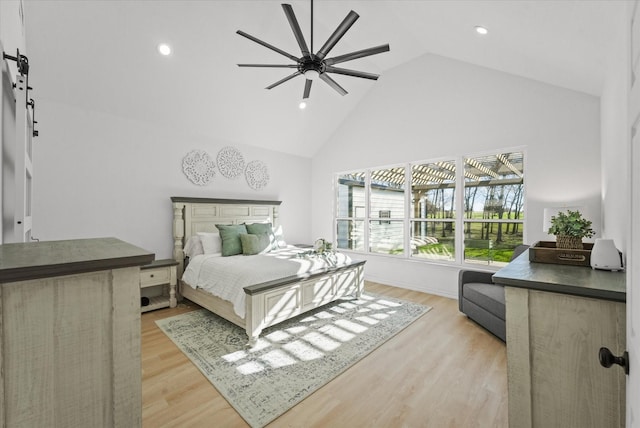 bedroom with ceiling fan, high vaulted ceiling, and light hardwood / wood-style flooring