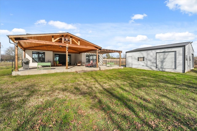 back of property featuring an outbuilding, a patio area, and a lawn