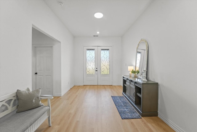 foyer entrance featuring french doors and light wood-type flooring