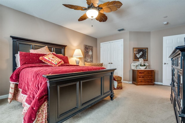 bedroom featuring a closet, visible vents, light carpet, and baseboards