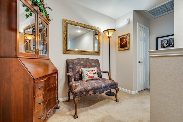 sitting room with baseboards, visible vents, and carpet flooring