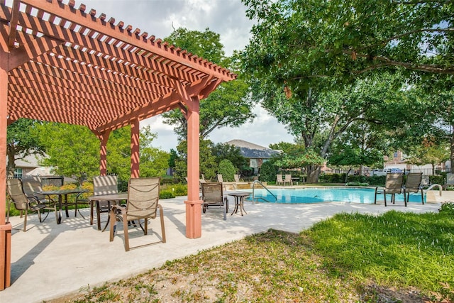 pool with a patio area and fence