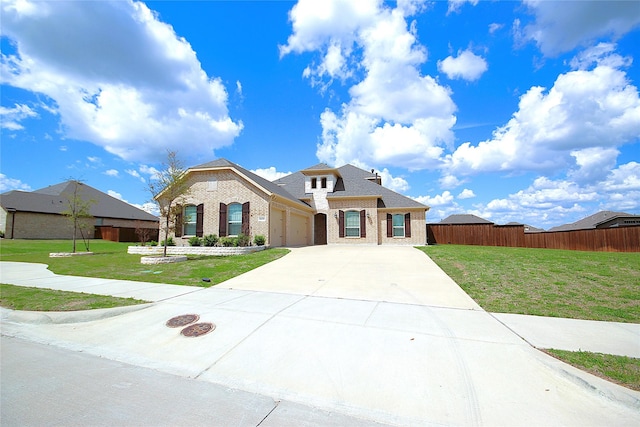 view of front of property featuring a garage and a front lawn