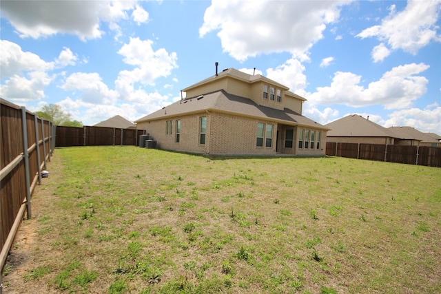 back of property with a lawn and cooling unit