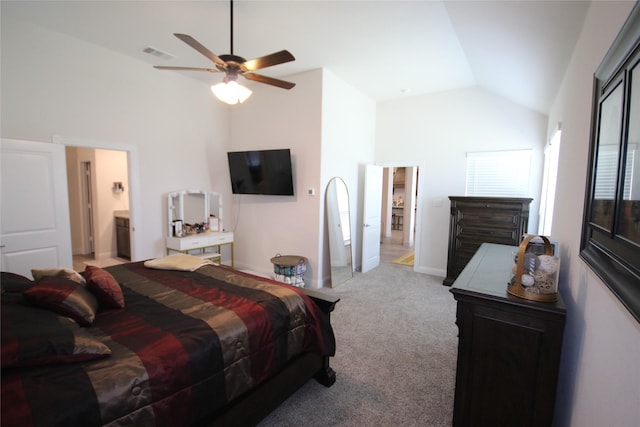 bedroom with connected bathroom, light colored carpet, high vaulted ceiling, and ceiling fan