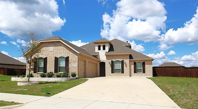 view of front of home with a garage and a front lawn