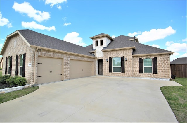 french country inspired facade with a garage