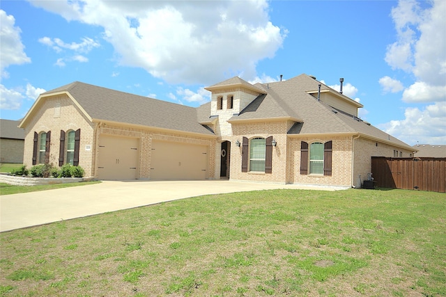 view of front of property with central air condition unit, a front lawn, and a garage