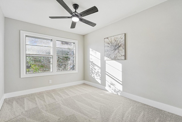 unfurnished room featuring light colored carpet and ceiling fan