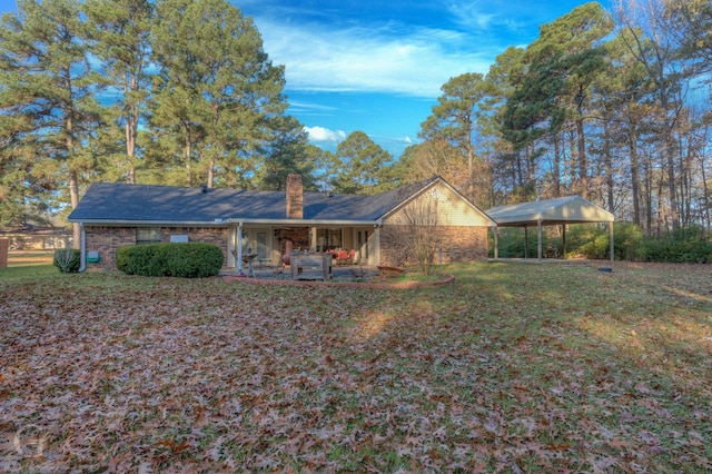 back of property with a patio area and a yard