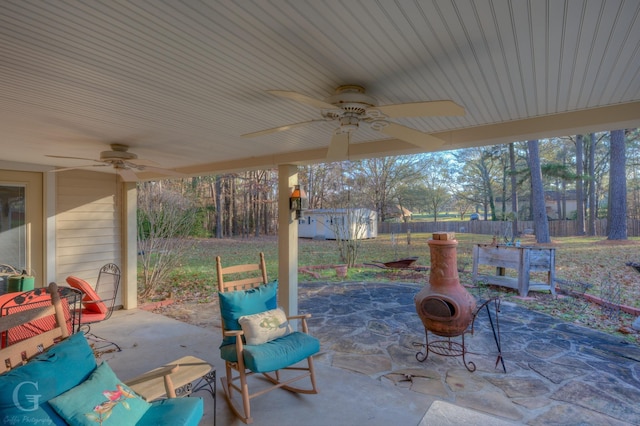 view of patio / terrace with ceiling fan and a shed