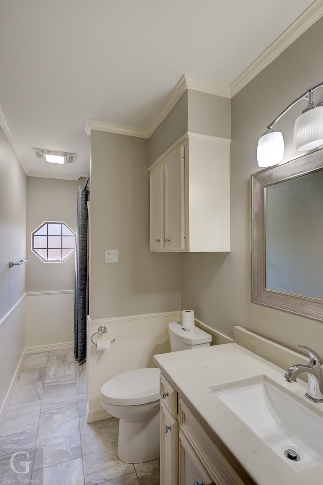 bathroom featuring crown molding, vanity, and toilet