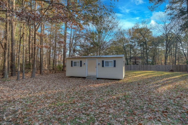 view of outbuilding featuring a lawn