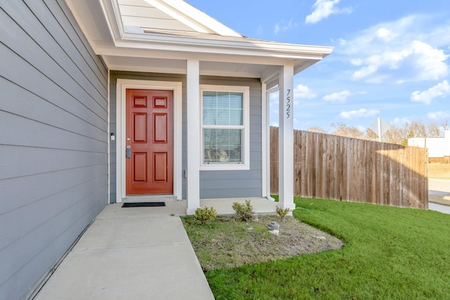 property entrance with a lawn