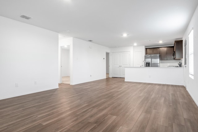 unfurnished living room with dark wood-type flooring