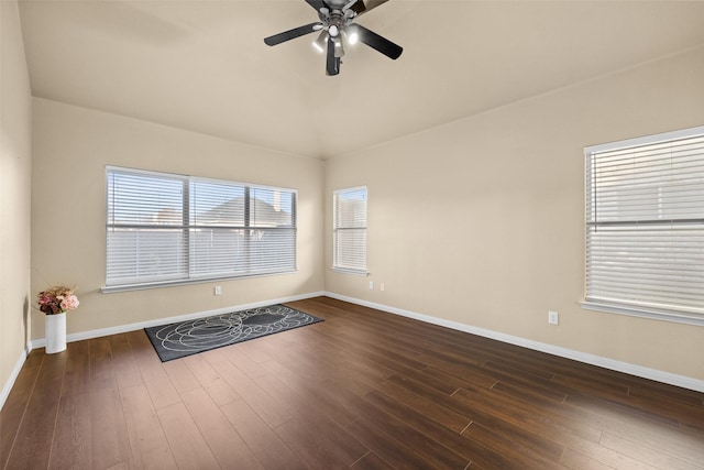 empty room with ceiling fan and dark hardwood / wood-style flooring