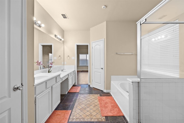 bathroom with vanity and a bathtub