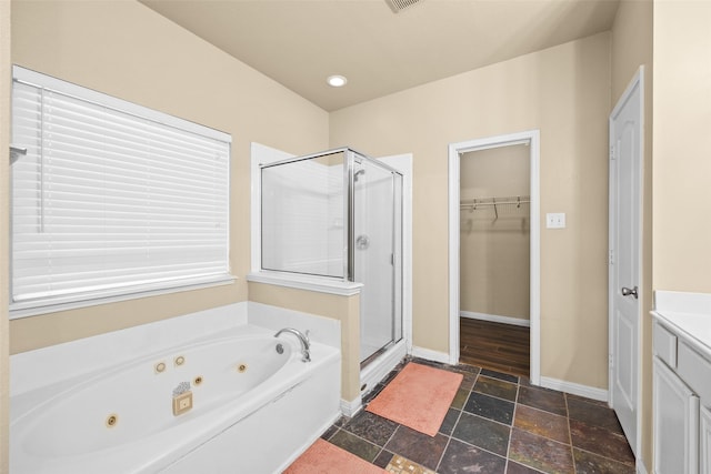 bathroom featuring vanity and plus walk in shower