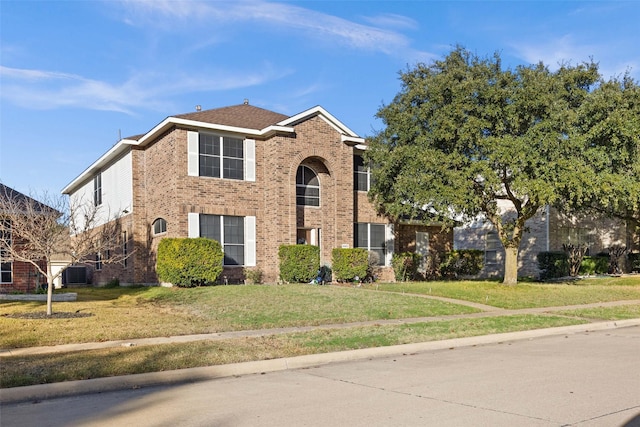 view of front of property with a front lawn and cooling unit