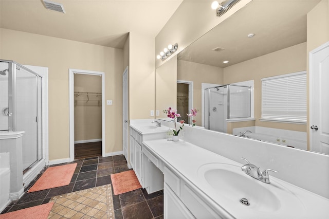 bathroom with vanity and shower with separate bathtub