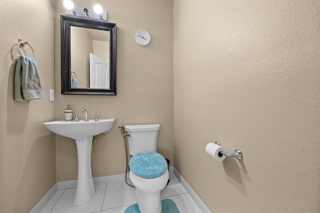 bathroom with tile patterned floors and toilet