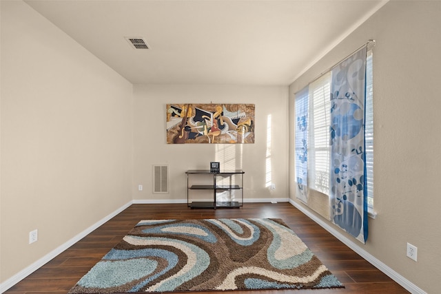 sitting room featuring dark wood-type flooring