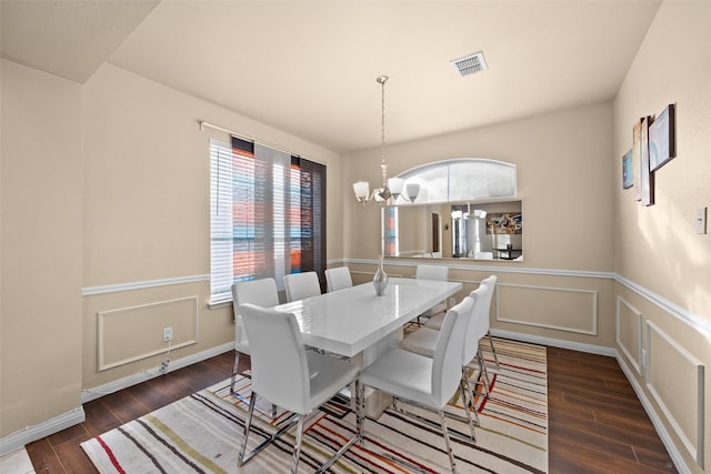 dining space with an inviting chandelier