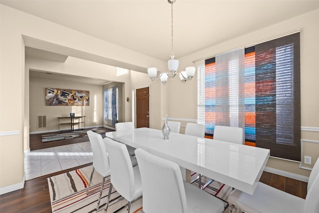 dining space with a chandelier