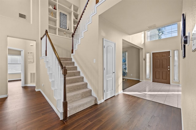 entryway featuring a high ceiling and dark wood-type flooring