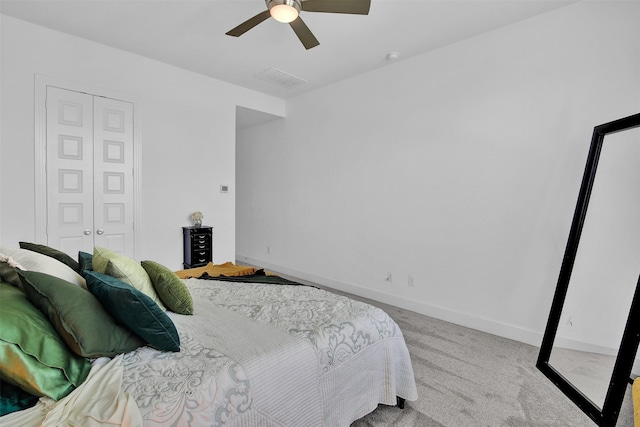 bedroom featuring light carpet, a closet, and ceiling fan