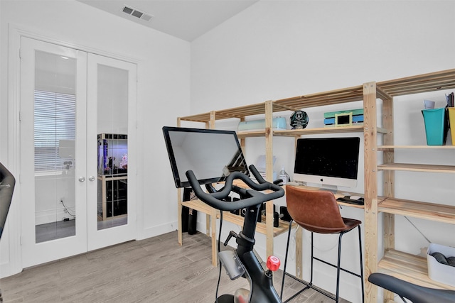 workout area featuring hardwood / wood-style flooring and french doors