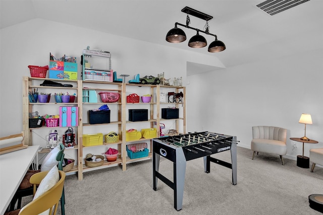 playroom featuring light colored carpet and lofted ceiling