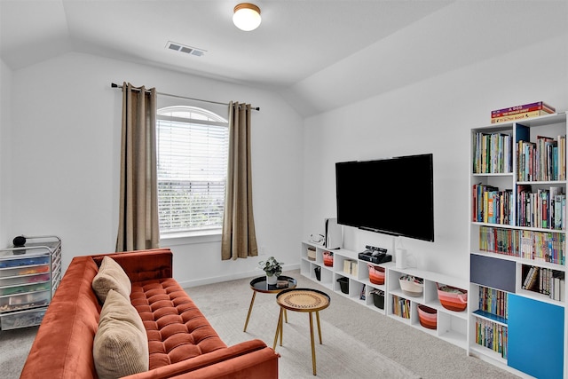 living room featuring carpet floors and lofted ceiling