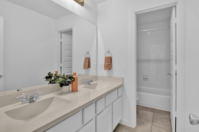 full bathroom with vanity, tiled shower / bath combo, tile patterned floors, and toilet