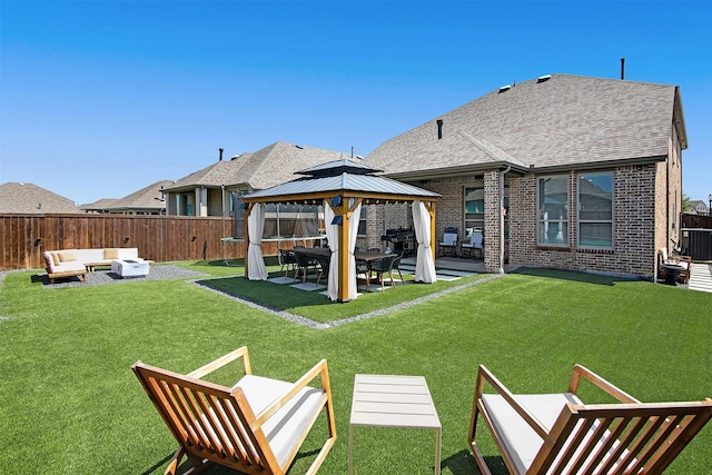 rear view of house with a gazebo, an outdoor hangout area, a patio area, and a lawn