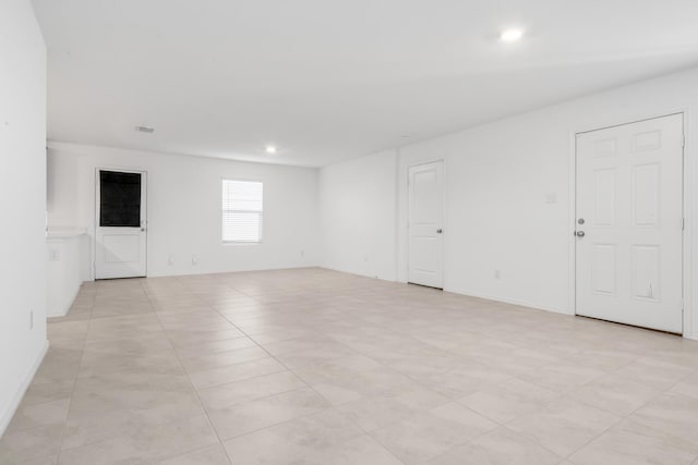 spare room featuring light tile patterned floors