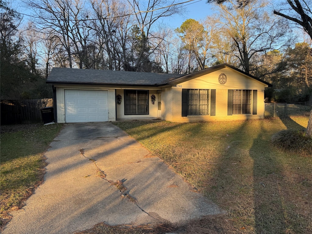 ranch-style house with a front yard and a garage