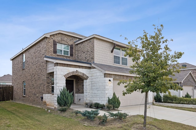 view of front of property featuring a front yard and a garage