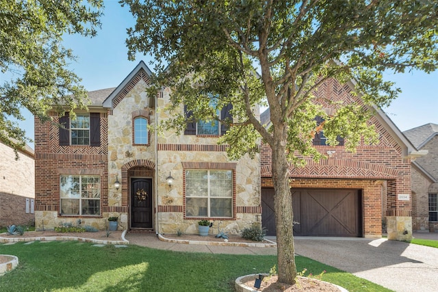 view of front of home with a garage and a front lawn