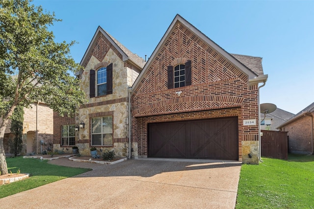 view of front of home featuring a front yard and a garage