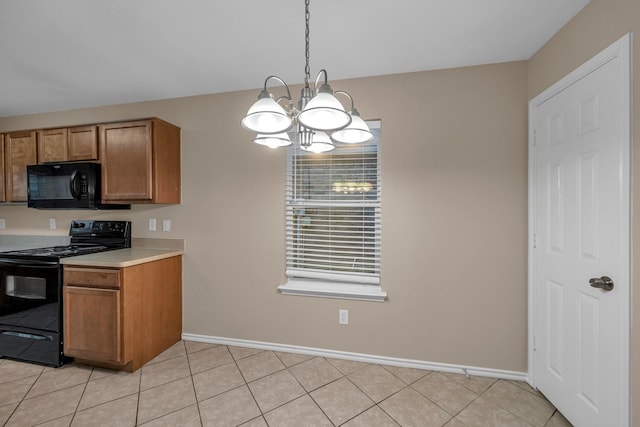 kitchen with hanging light fixtures, light tile patterned floors, black appliances, and a chandelier