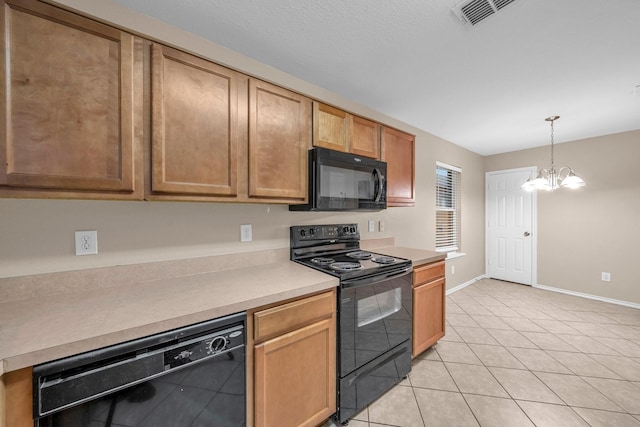 kitchen with decorative light fixtures, light tile patterned floors, an inviting chandelier, and black appliances