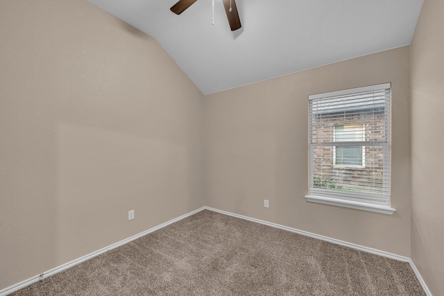 carpeted spare room featuring ceiling fan and lofted ceiling