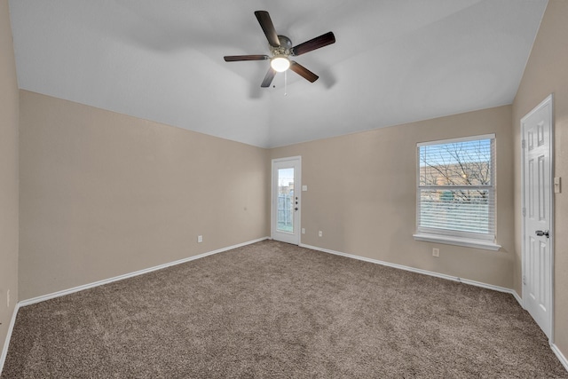 spare room featuring vaulted ceiling, plenty of natural light, carpet flooring, and ceiling fan