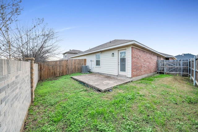 back of property featuring cooling unit, a patio, and a lawn