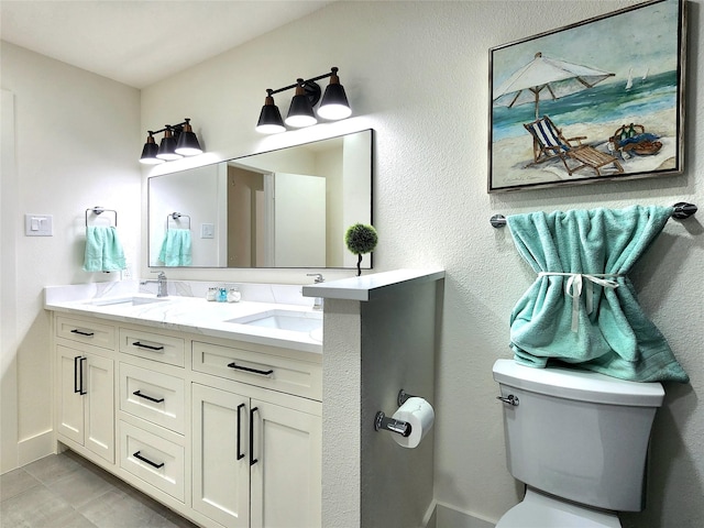 bathroom with tile patterned floors, vanity, and toilet